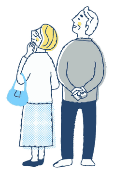 景色を見上げる夫婦の後ろ姿